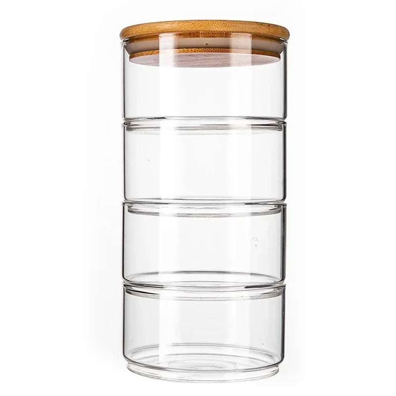 Clear glass storage jars with bamboo lids on a white background