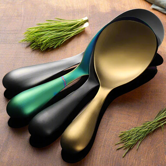 Set of four spoons in gold, silver, green, and black on a gray background