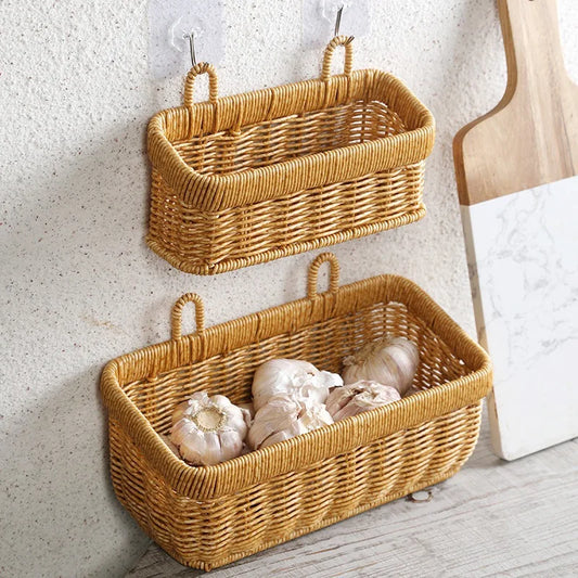 Two wicker wall baskets hanging on a textured wall with a wooden chair and whiteboard in the background.
