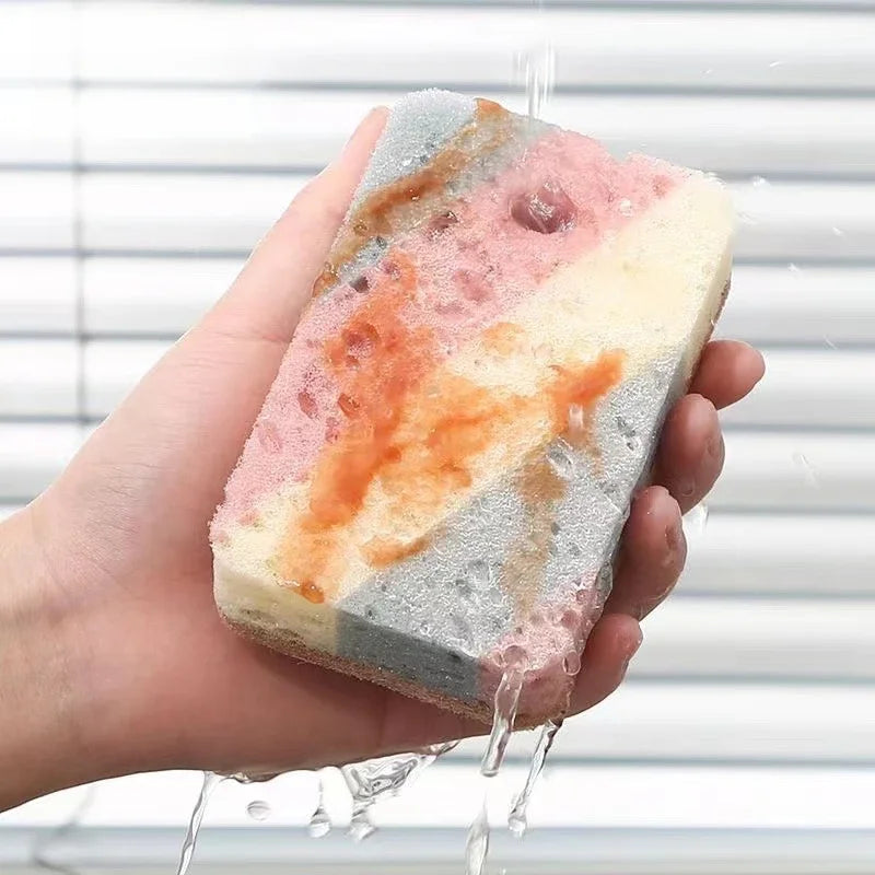 Hand holding a colorful sponge with water streaming over it against a neutral background