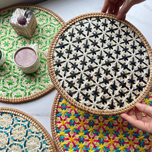 Woven placemats with geometric patterns on a table.