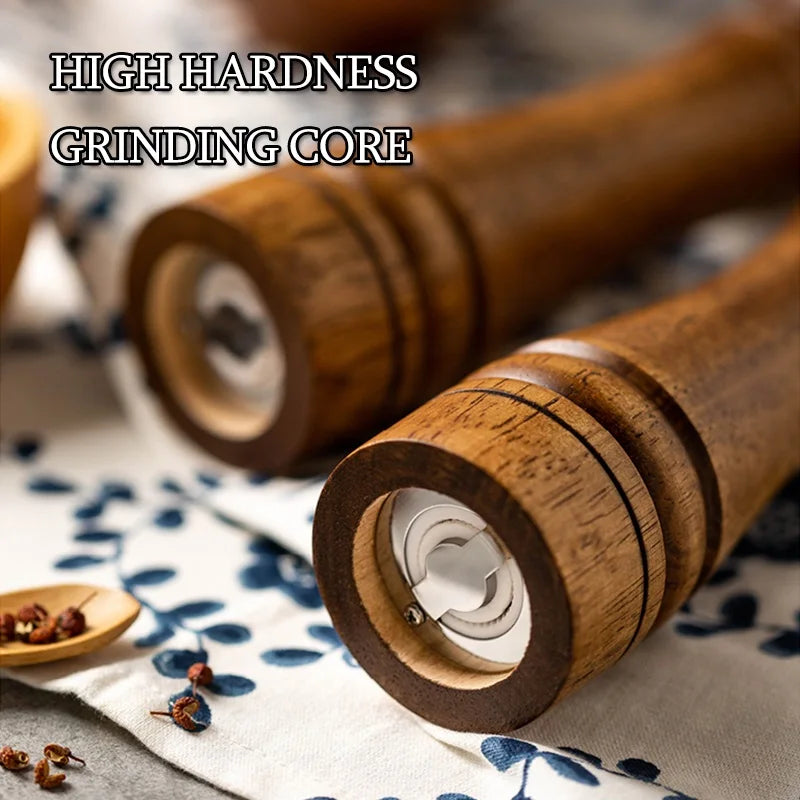 Wooden pepper grinders on a patterned cloth with text 'High Hardness Grinding Core'.