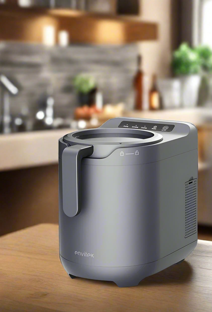 Envitek Recycle Food Machine in a modern kitchen setting, showcasing its sleek black design and stainless steel grinding chamber for effective food waste composting.