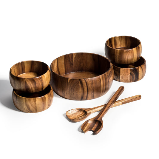 Dragor 7-piece Acacia wood salad bowl set, featuring a large 10-inch bowl, four individual bowls, and two serving utensils with a natural wood grain finish.