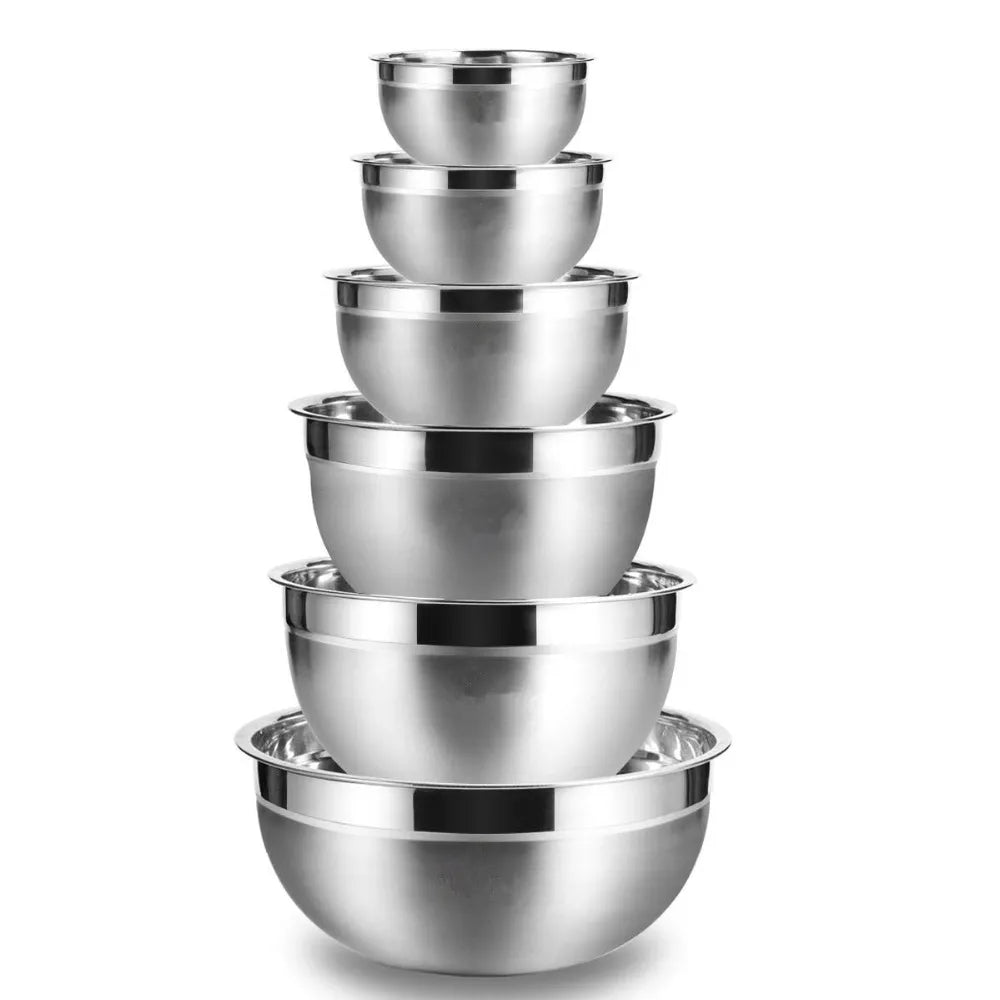 Set of stainless steel mixing bowls stacked on a white background