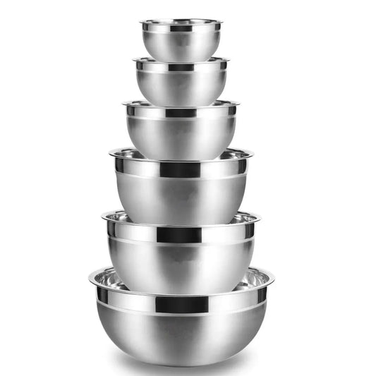 Set of stainless steel mixing bowls stacked on a white background