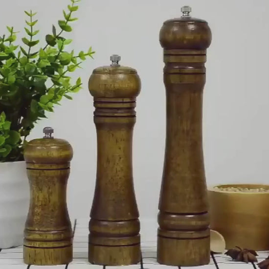 EcoNest Popnova wooden pepper mills in 5, 8, and 10 inches shown grinding pepper and salt; adjustable ceramic core, ergonomic wooden body, eco-friendly and safety-certified.