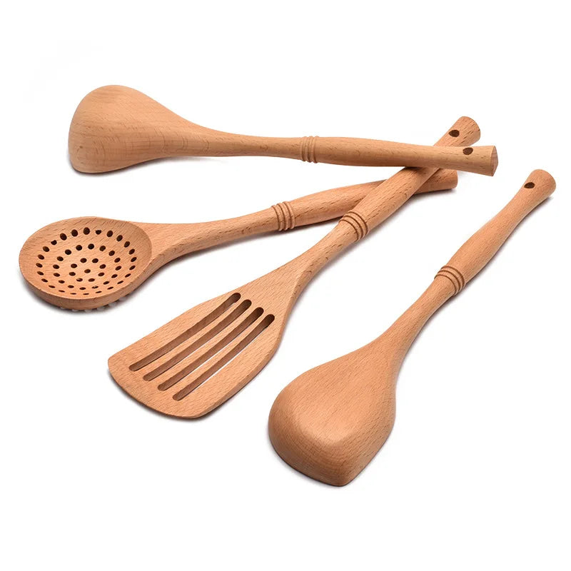 Natural wood kitchen utensils set including spatula and spoon for eco-friendly, non-stick cooking.
