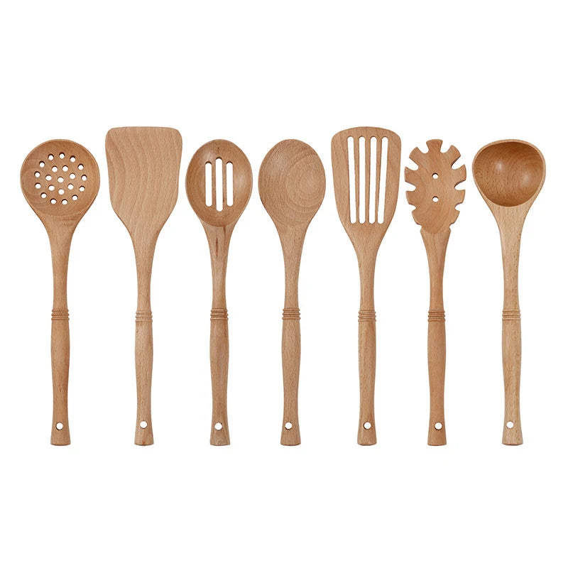 Natural wood kitchen utensils set including spatula and spoon for eco-friendly, non-stick cooking.